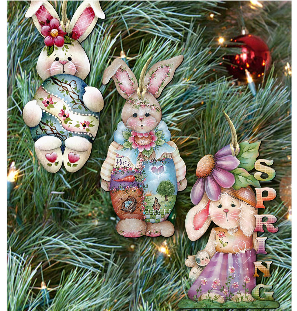 three colorful Easter bunny ornaments hanging on a Christmas tree.