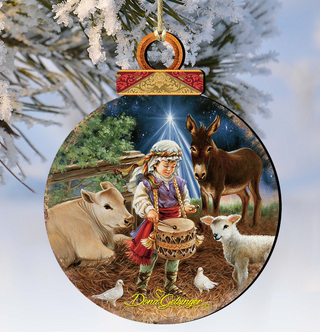 A Christmas ornament depicting a young boy playing a drum, surrounded by animals such as a donkey, sheep, and a cow, with a starry night sky in the background.