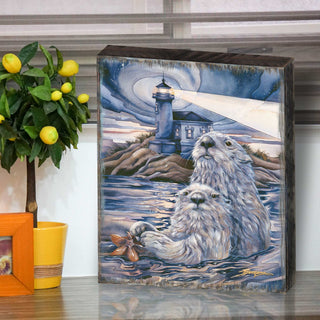a wooden frame with a painting of two otters sitting in the water, with a lighthouse in the background.