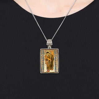 A silver pendant necklace with a rectangular pendant featuring an image of a religious figure.