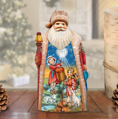 A hand-carved wooden Santa Claus figurine with a colorful, detailed design depicting a nativity scene with people, animals, and a moon.