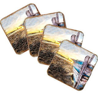 a collection of four square coasters, each featuring a different beach scene. The coasters display various beach elements, such as a pier, a boat, and a sunset.