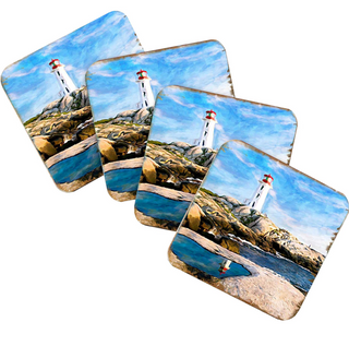 A set of four coasters featuring a lighthouse on a rocky coastline with a body of water in the background.