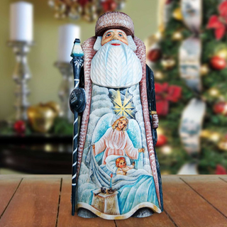 A wooden Santa Claus figurine with a detailed design, standing on a wooden surface.