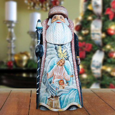 A wooden Santa Claus figurine with a detailed design, standing on a wooden surface.
