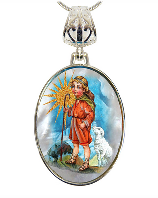 a pendant with a circular design, depicting a young boy in an orange outfit standing next to a white dog.