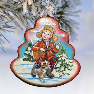 A Christmas ornament depicting a young girl playing a guitar and a dog, set against a snowy winter landscape with pine trees.
