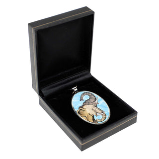 a pendant with an elephant design, displayed in a black jewelry box.