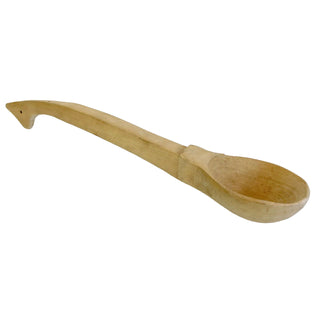 A wooden ladle with a curved handle, resting on a white surface.