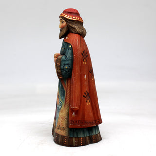 a figurine of a man with a red hat and coat