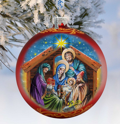A red and gold ornament depicting the Holy Family in a nativity scene, with the baby Jesus surrounded by the Magi and the Wise Men.