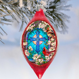 A red Christmas ornament with a stained glass design, featuring a cross and flowers, hangs from a tree branch against a snowy background.