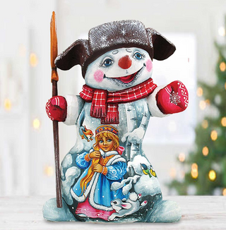 A snowman figurine with a smiling face, wearing a red scarf and holding a stick, is the main focus of the image.
