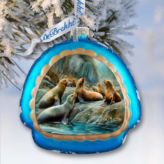 a blue ornament hanging from a tree