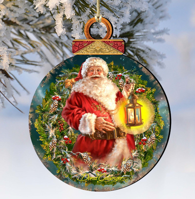 A round ornament featuring a painting of Santa Claus holding a lantern, surrounded by a wreath of pine branches and berries.