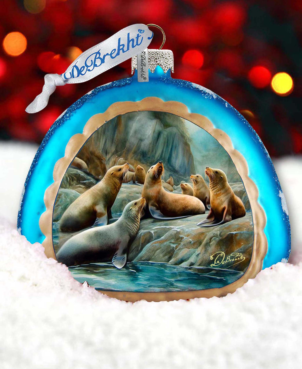 a glass ornament with a picture of sea lions