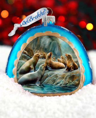 a glass ornament with a picture of sea lions