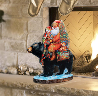 a statue of santa claus riding a bear in front of a fireplace