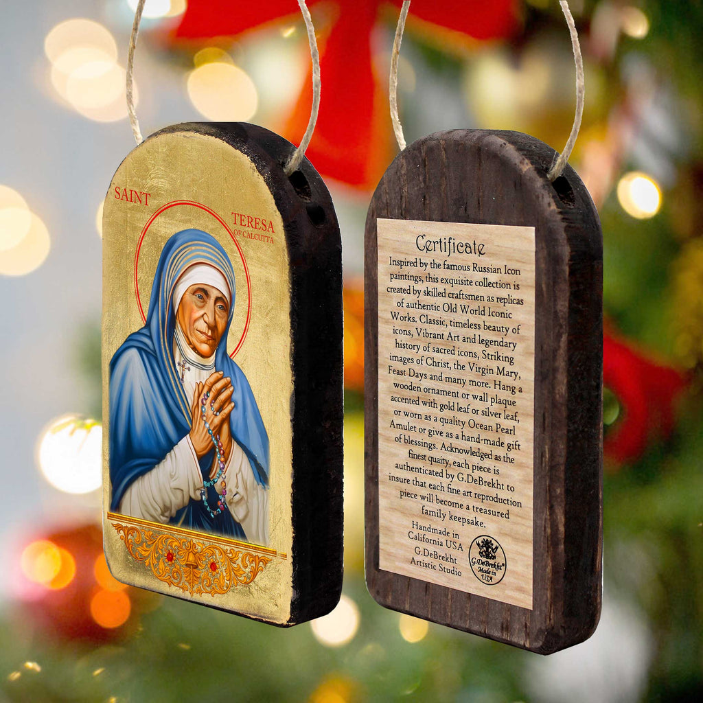 two wooden ornaments, each depicting a religious figure, likely a saint or religious icon. The ornaments are hanging from a string, and there is a label attached to one of them providing information about the ornament.