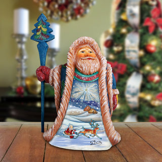 A figurine of Santa Claus holding a blue staff and a wreath, with a snowy landscape and reindeer depicted on the front.
