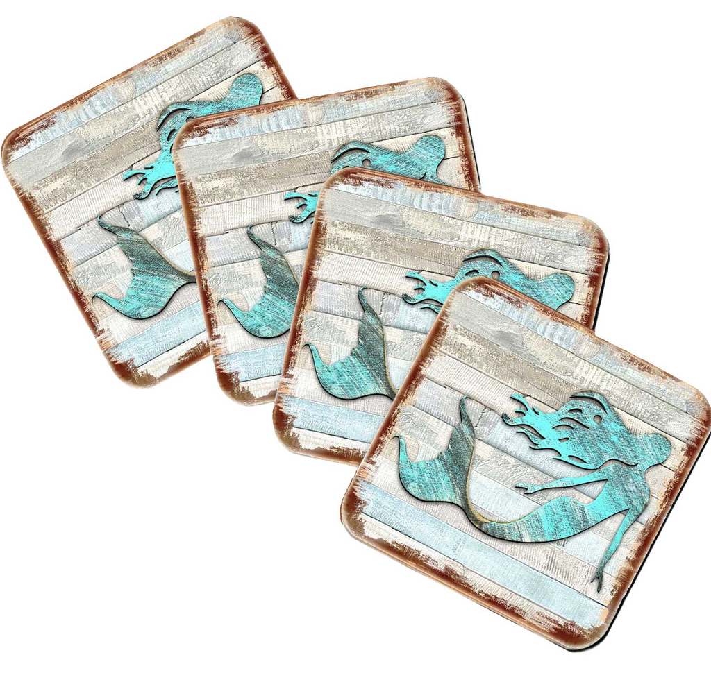 four square coasters with a mermaid design on them.