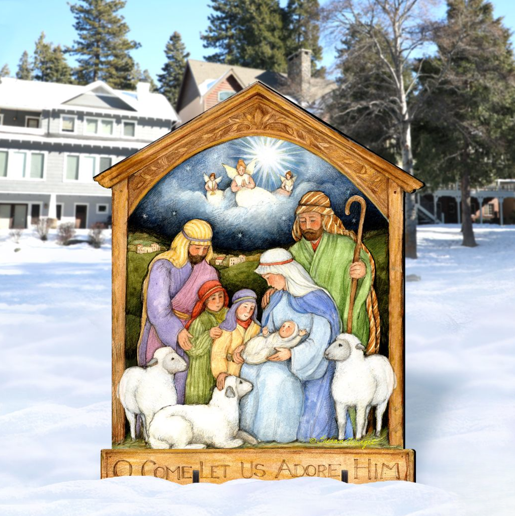 A wooden nativity scene depicting the birth of Jesus Christ, with figures of the Virgin Mary, Joseph, and baby Jesus surrounded by animals. The scene is set in a snowy outdoor environment with a house and trees in the background.