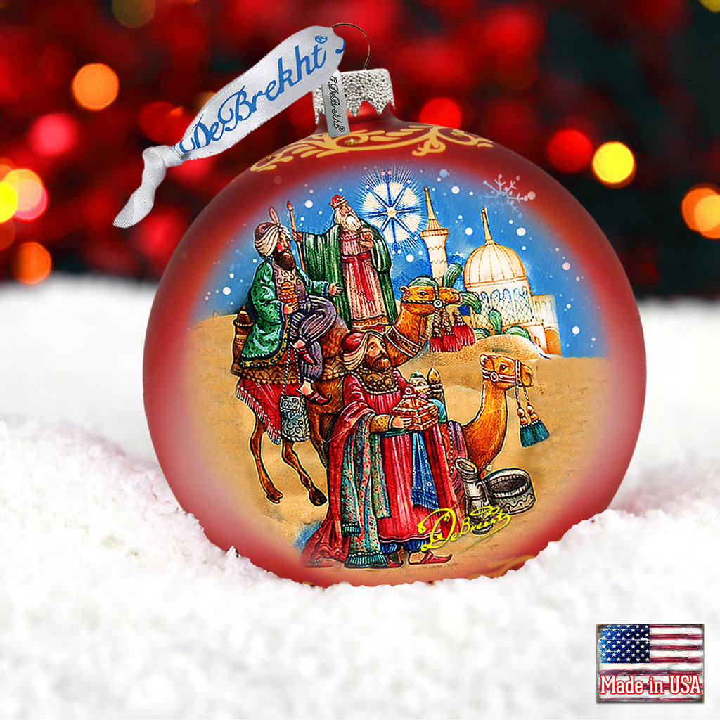 a christmas ornament with a picture of a family on a sleigh