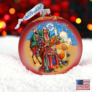 a christmas ornament with a picture of a family on a sleigh
