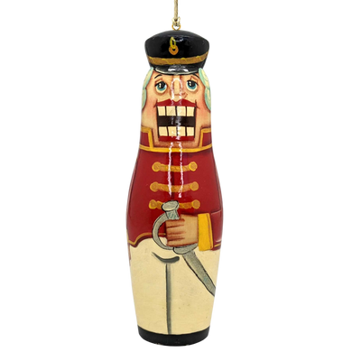 A nutcracker ornament with a red and gold color scheme, featuring a soldier-like figure holding a sword.