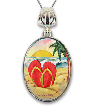 A pendant necklace with a circular design featuring a beach scene with a palm tree, a sunset, and two red flip-flops.