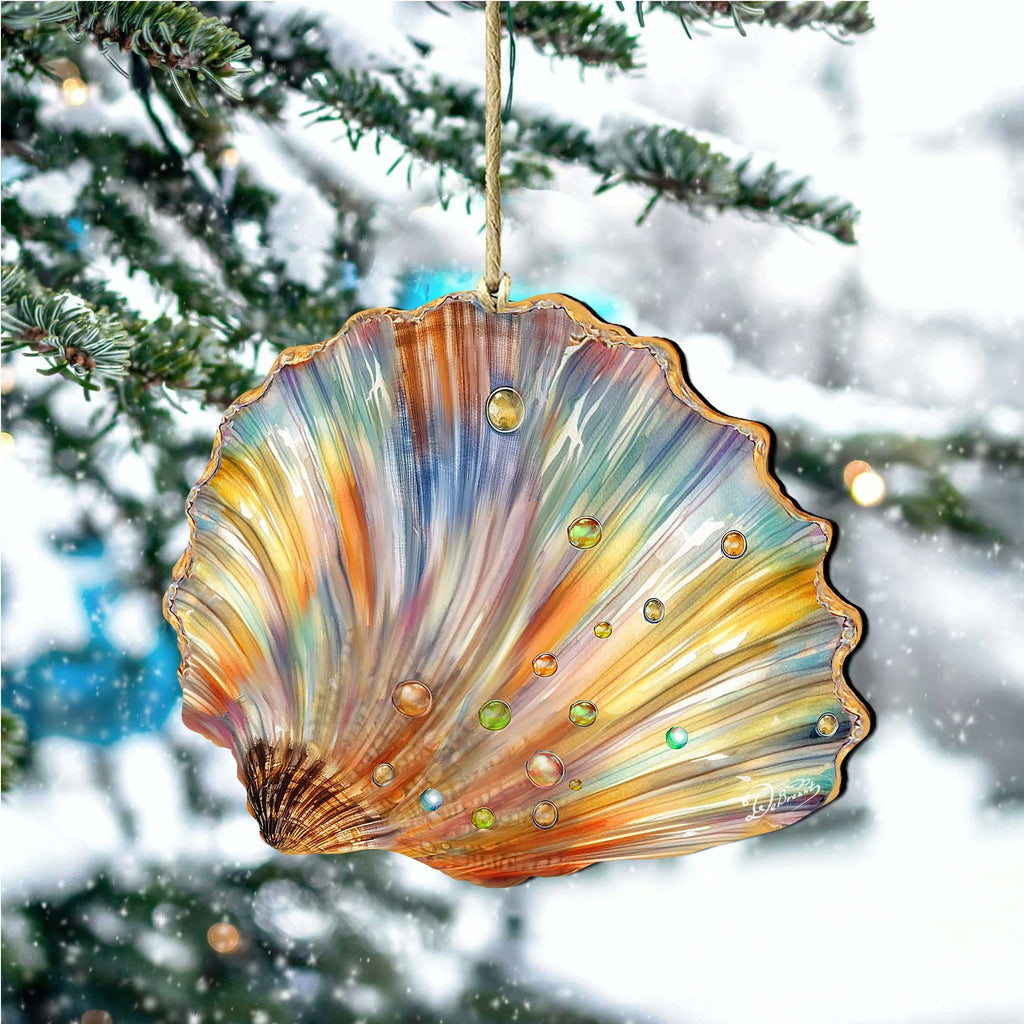 A colorful, multicolored seashell ornament hangs from a tree branch, with snowflakes visible in the background.