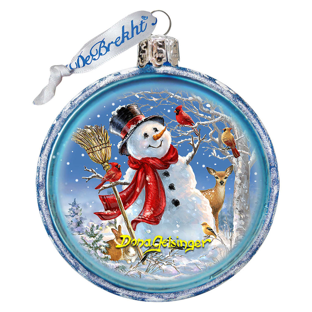 a glass ornament with a snowman holding a broom