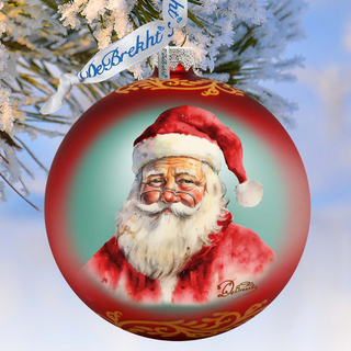 A red Christmas ornament with a painting of Santa Claus on it, hanging on a tree branch with snow on the branches.