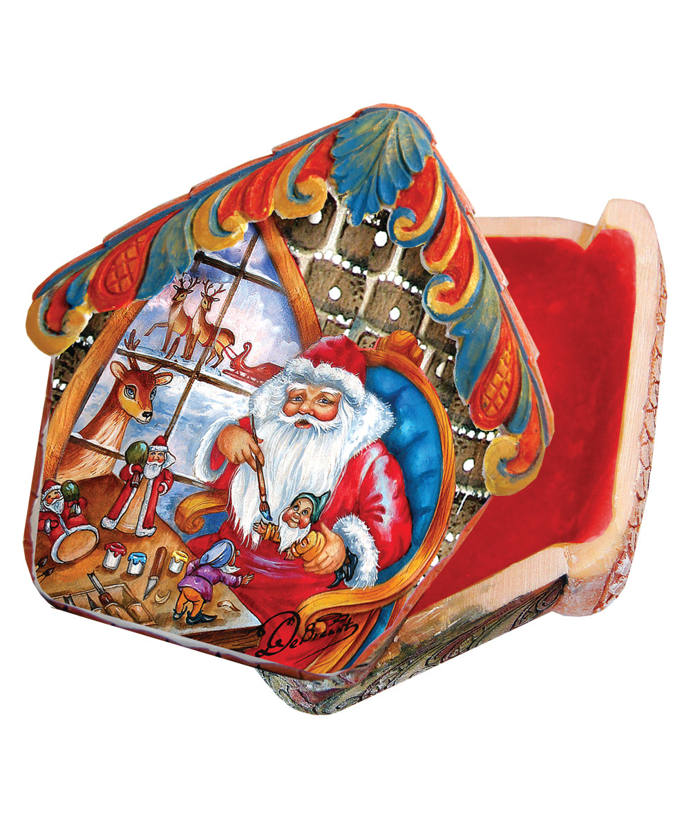 a colorful, hand-painted box depicting a Santa Claus figure sitting in a chair, surrounded by various holiday-themed elements such as reindeer, snowflakes, and a Christmas tree.