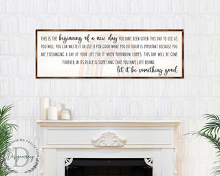a framed inspirational quote on a white wall above a fireplace, which reads: