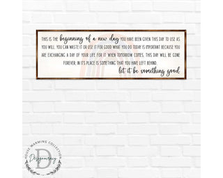 a framed inspirational quote on a white brick wall.