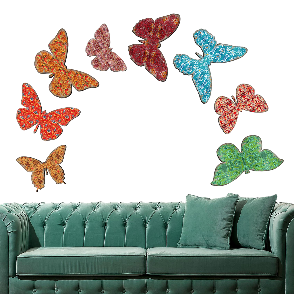 a green couch with colorful butterfly-shaped wall art above it.