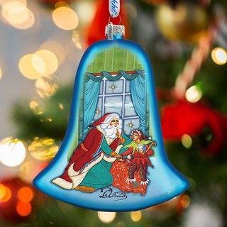 A blue bell ornament with a Santa Claus and a young girl on it, hanging on a Christmas tree.