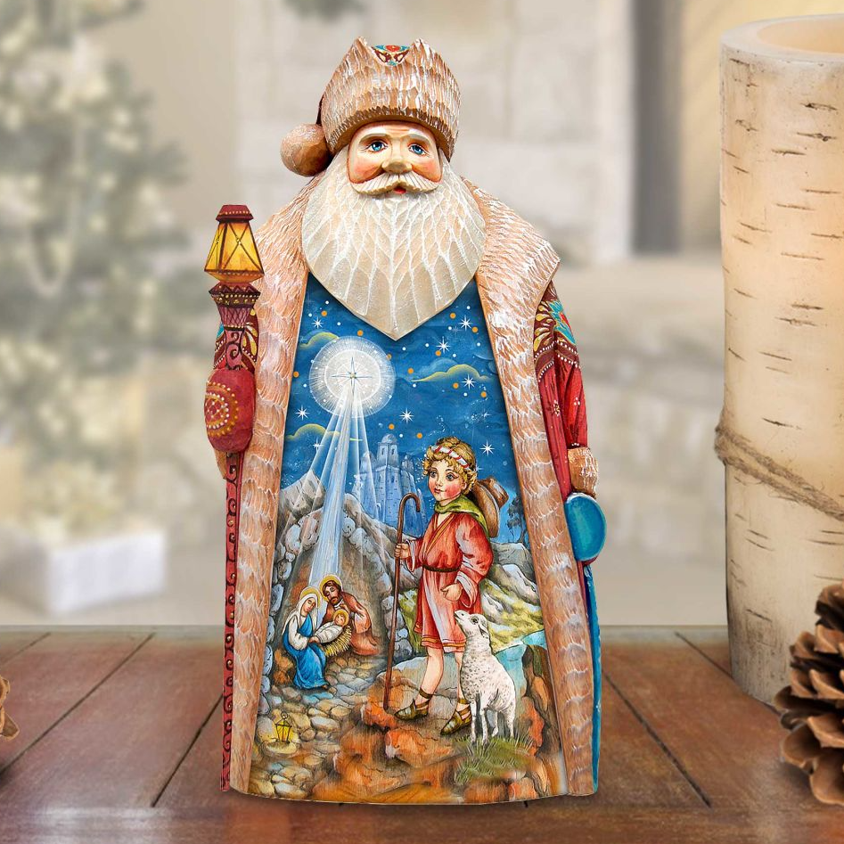 A detailed figurine of Santa Claus, with a nativity scene depicted inside the figure.