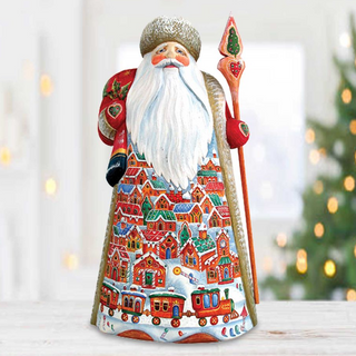 A colorful and detailed figurine of Santa Claus holding a staff and a Christmas tree in the background.