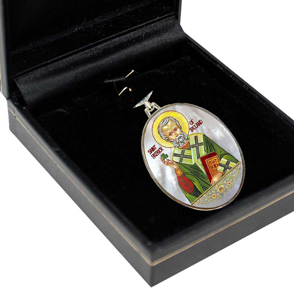 A pendant in a black box, featuring a religious icon of a saint.