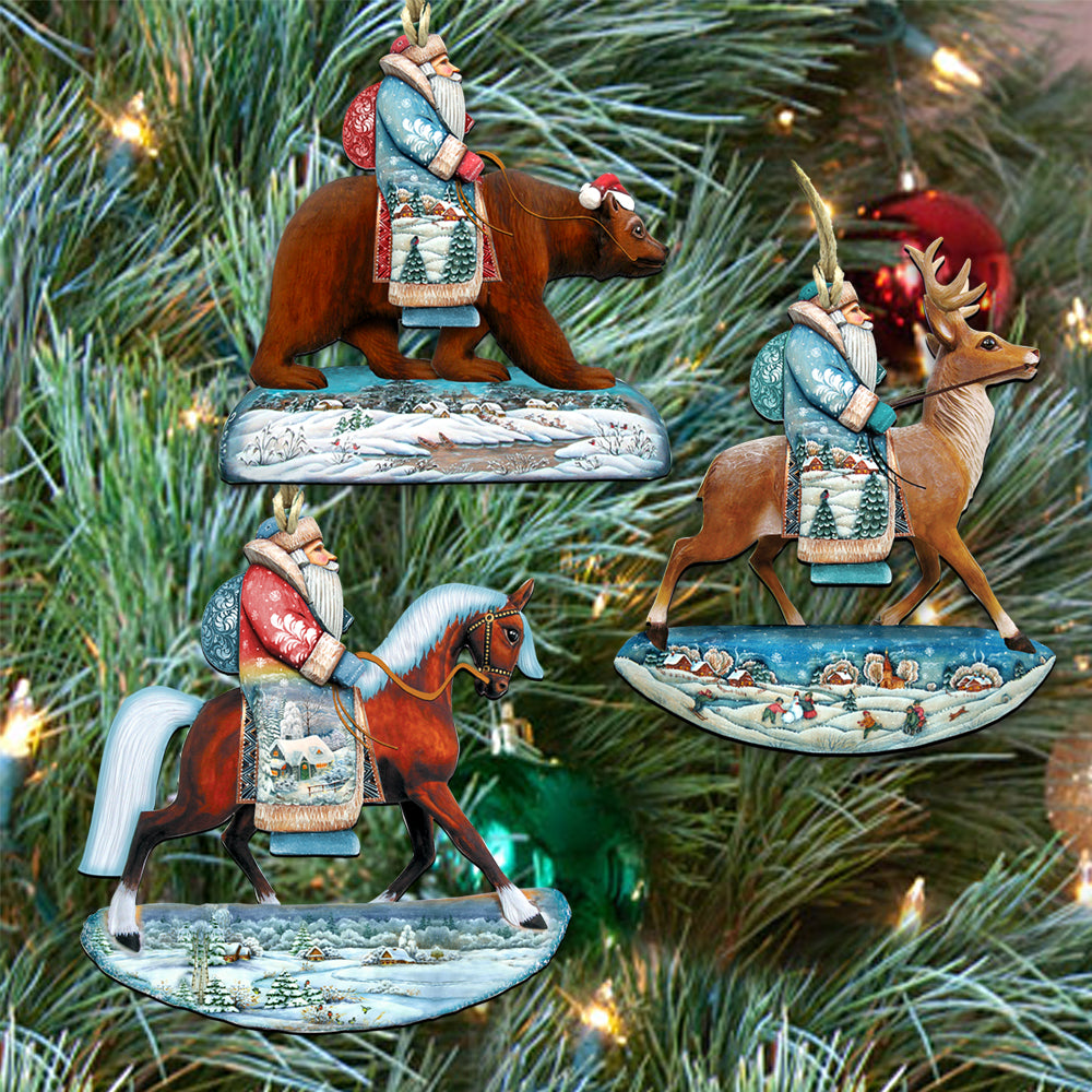 a collection of three ornaments hanging on a Christmas tree, each depicting a different winter scene with a Santa Claus figure riding a bear, a reindeer, and a horse.