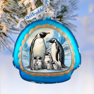 a christmas ornament with a picture of penguins on it