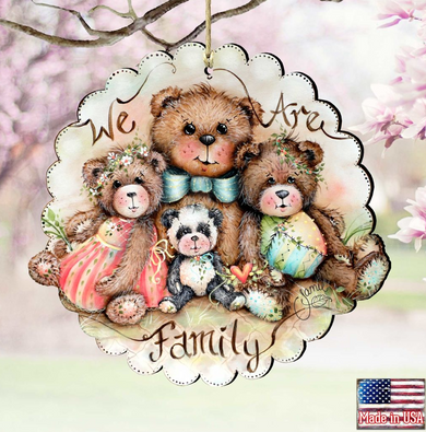 A decorative ornament featuring three teddy bears, with the text