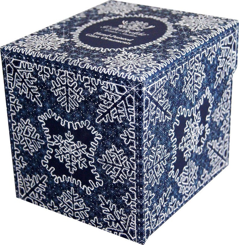 A blue and white box with a snowflake pattern, featuring a central circular design.