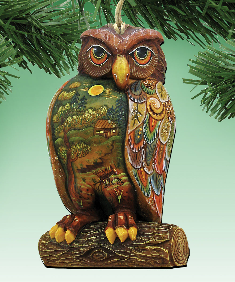 A colorful, hand-painted ornament of an owl sitting on a tree branch, with intricate details and patterns.