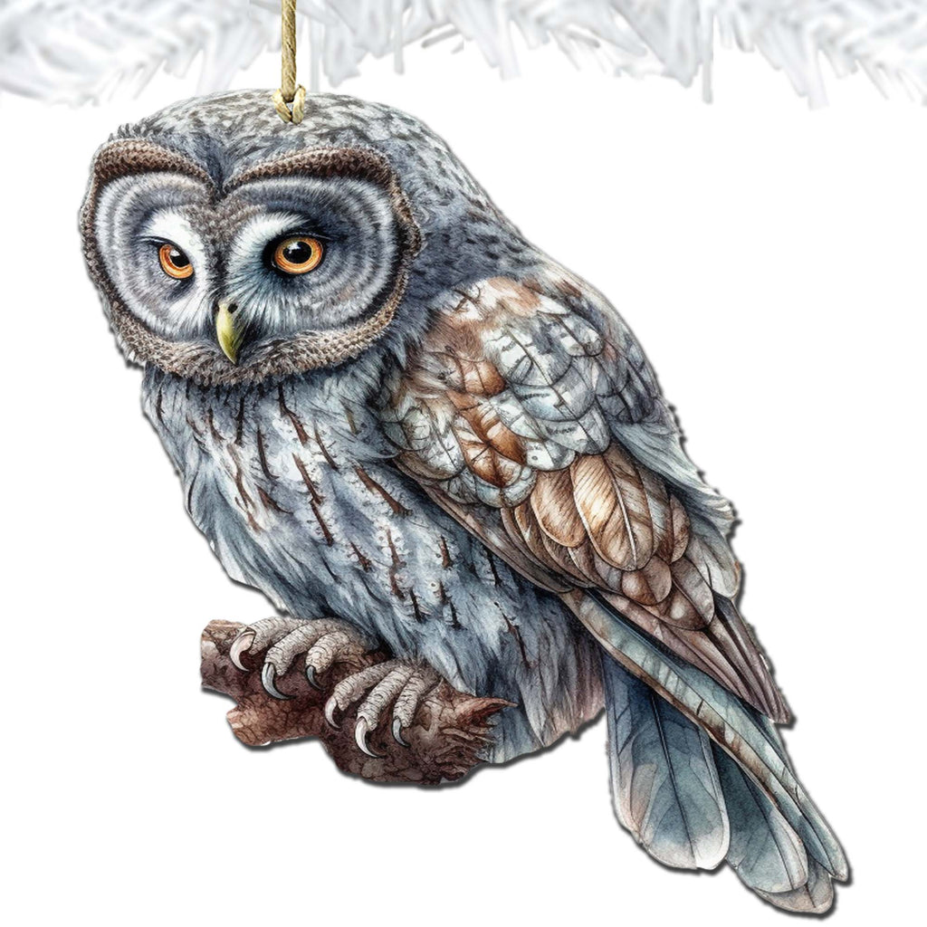 an owl ornament hanging from a christmas tree
