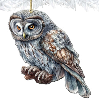 an owl ornament hanging from a christmas tree