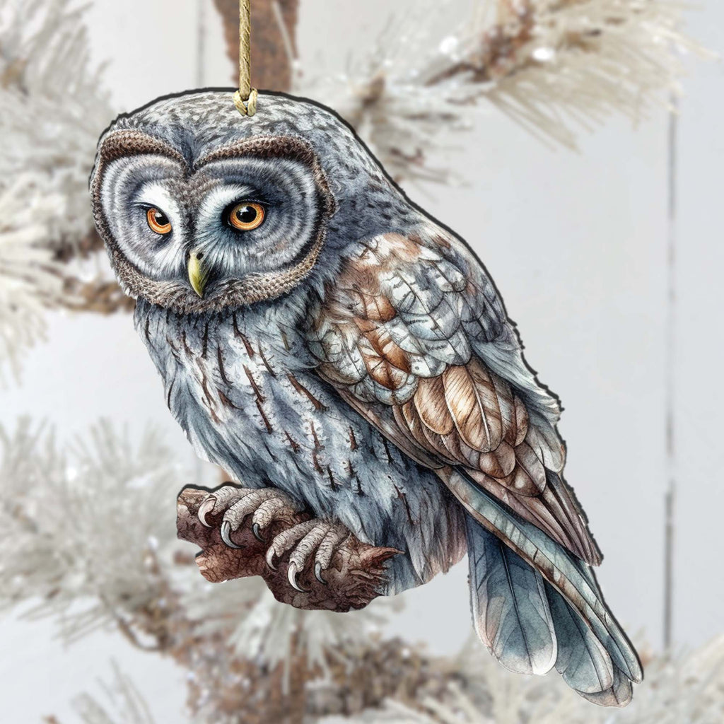 an owl ornament hanging from a christmas tree
