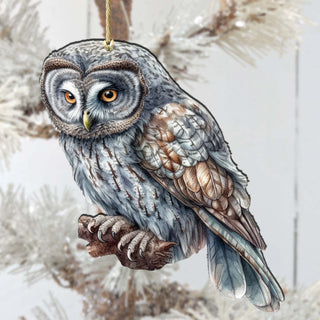an owl ornament hanging from a christmas tree